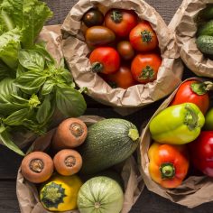 Close up of fresh eco vegetables in coton bags on wood Close up of fresh eco vegetables in coton bags on wooden background